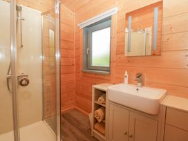 A bathroom with shower and sink at Oak Lodge in Pennington near Ulverston