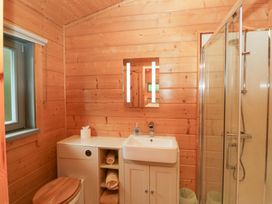 A bathroom with a sink and shower at Oak Lodge Pennington near Ulverston