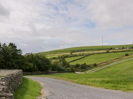 A rural landscape with a dirt road and hills at Oak Lodge in Pennington near Ulverston