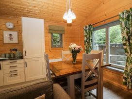A dining room with a table and chairs at Oak Lodge Pennington near Ulverston