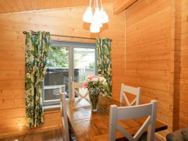 A dining room with a wooden table and chairs at Oak Lodge Pennington near Ulverston