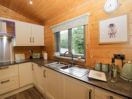 A kitchen with cabinets and a sink at Oak Lodge Pennington near Ulverston