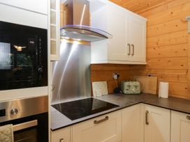 A kitchen with oven and cooktop at Oak Lodge Pennington near Ulverston
