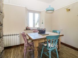 A dining room with a table and chairs at Tyn Morfa Llangwnnadl near Aberdaron