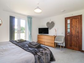 A bedroom with a bed and television at Tyn Morfa in Llangwnnadl near Aberdaron