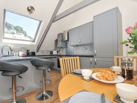 A kitchen with a table set for breakfast at Beach Retreat in Looe