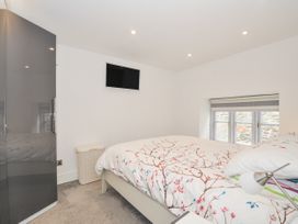 A bedroom with a bed and wardrobe at Beach Retreat in Looe