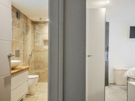 A bathroom with a shower and sink at Beach Retreat in Looe