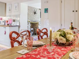 A dining room with a table set for a meal at Puffitts Cottage in Bourton-on-the-Water