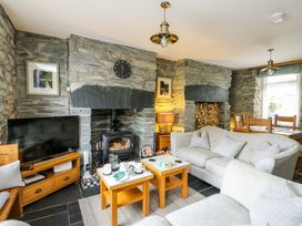 A living room with a fireplace and sofa at Garreg Ddu in Blaenau Ffestiniog