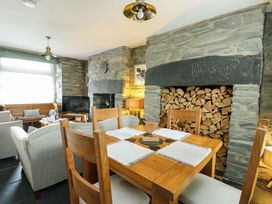 A dining room with a wooden table and chairs at Garreg Ddu in Blaenau Ffestiniog