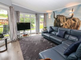 A living room with a sofa and television at 16 Badgers Retreat in Richmond