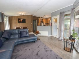 A living room with a couch and dining area at 16 Badgers Retreat in Richmond