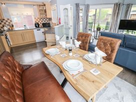A dining area with a table set for meals at 16 Badgers Retreat in Richmond