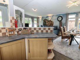 A kitchen with a dining area and wall art at 16 Badgers Retreat in Richmond