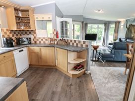 A kitchen with a microwave and dishwasher at 16 Badgers Retreat in Richmond