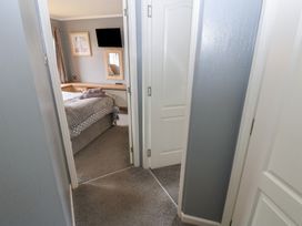 A bedroom view showing a bed and a mirror at 16 Badgers Retreat in Richmond