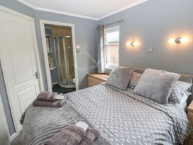 A bedroom with a bed and an ensuite shower at 16 Badgers Retreat in Richmond