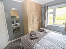 A bedroom with a bed and wardrobe at 16 Badgers Retreat in Richmond