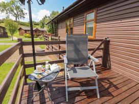 An outdoor seating area with a chair and table at 16 Badgers Retreat in Richmond