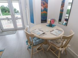 A dining room with a round table and chairs at Beachcomber in Marazion