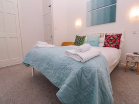 A bedroom with a bed and decorative pillows at Beachcomber in Marazion