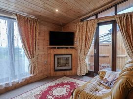 A snug with a television and fireplace at The Cabin at East Hill Pride Four Elms Hill Nr. Sidmouth