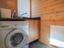 A laundry room with a washing machine and sink at The Cabin at East Hill Pride in Four Elms Hill Nr. Sidmouth