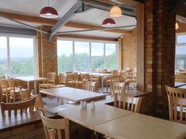 A dining room with tables and chairs at The Cabin at East Hill Pride Four Elms Hill Nr. Sidmouth
