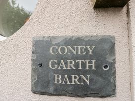 A stone plaque with the name 'Coney Garth Barn' at Coney Garth Barn in Beckermet
