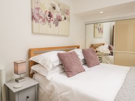 A bedroom with a bed and wall art at Coney Garth Barn in Beckermet