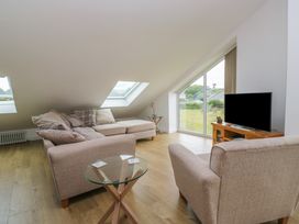 A living room with a sofa and television at Coney Garth Retreat in Beckermet