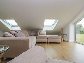 A living room with a sofa and skylights at Coney Garth Retreat in Beckermet
