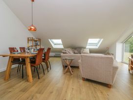 A living room with a dining area and a sofa at Coney Garth Retreat in Beckermet