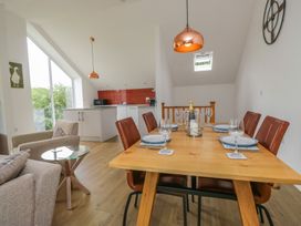A dining room with a table and chairs at Coney Garth Retreat in Beckermet
