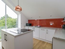 A kitchen with a microwave and kettle at Coney Garth Retreat in Beckermet