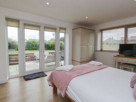 A bedroom with a bed and wardrobe at Coney Garth Retreat in Beckermet