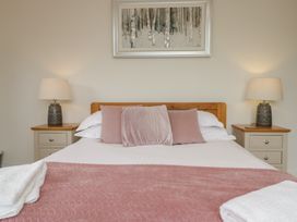 A bedroom with a bed and side tables at Coney Garth Retreat in Beckermet