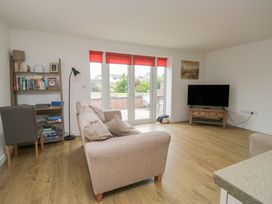 A living room with a sofa and television at Coney Garth Cottage in Beckermet