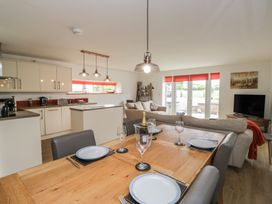 A kitchen and dining area with a table and chairs at Coney Garth Cottage in Beckermet