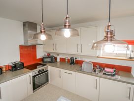 A kitchen with appliances and countertops at Coney Garth Cottage in Beckermet