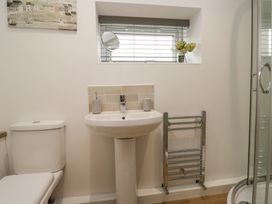 A bathroom with a sink and toilet at Coney Garth Cottage Beckermet