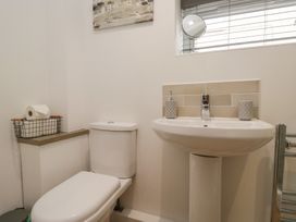 A bathroom with a toilet and sink at Coney Garth Cottage in Beckermet