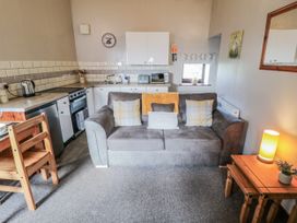 A kitchen with a sofa and dining area at Carters in Staintondale
