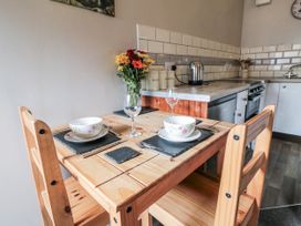 A kitchen with a wooden table and chairs at Carters in Staintondale