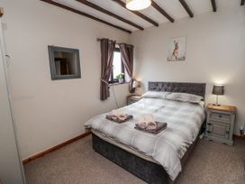 A bedroom with a bed and bedside table at Carters in Staintondale