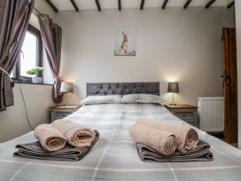 A bedroom with a bed and towels on the sheets at Carters in Staintondale