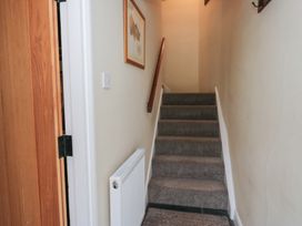A staircase with a handrail and framed picture at Rose Cottage Broughton-In-Furness