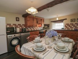 A kitchen with a table set for dining at Rose Cottage in Broughton-In-Furness