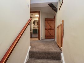 A staircase leading to a hallway at Rose Cottage in Broughton-In-Furness